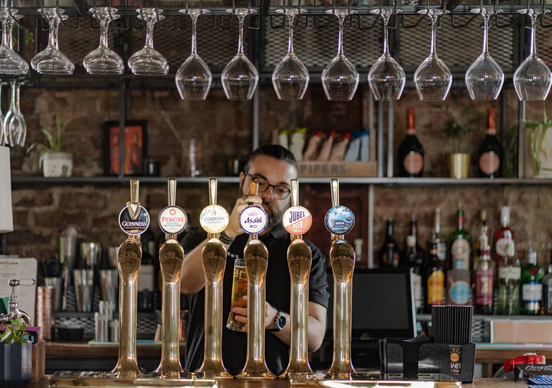 Team member pouring beer at the bar